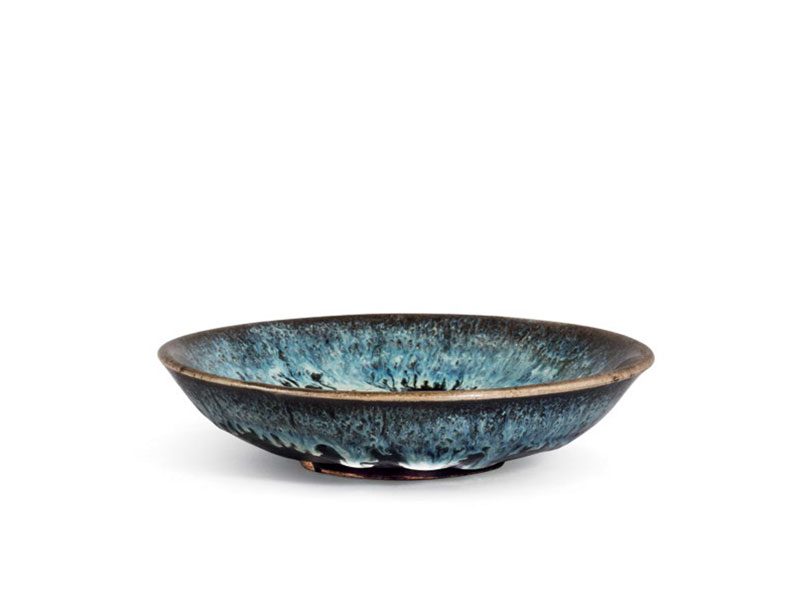 Black glazed stoneware saucer with milky-blue splashes